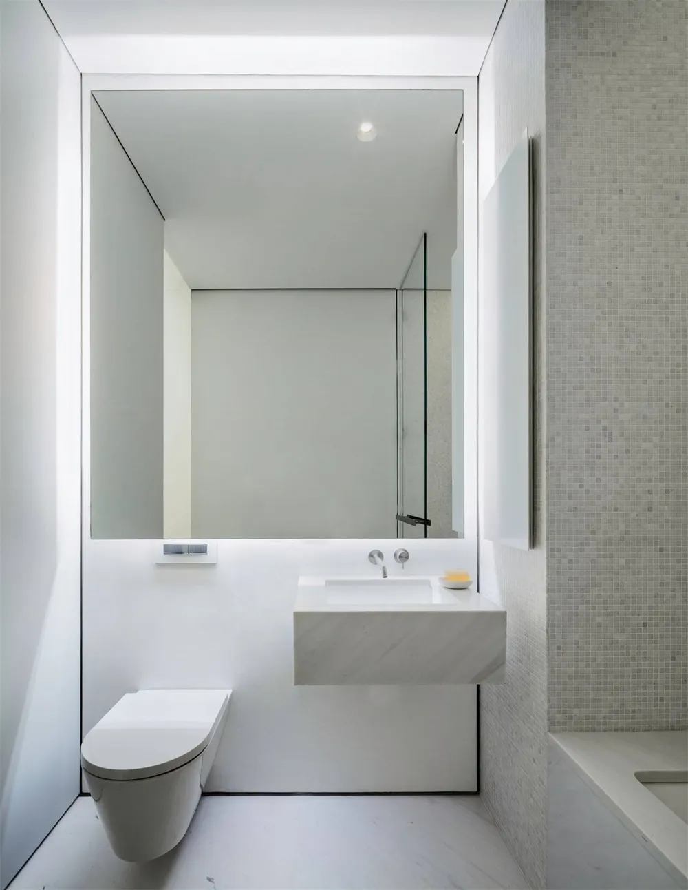 White marble bathroom with modern fixtures and minimalist design