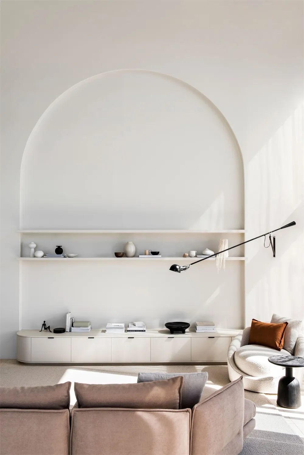 A minimalist living room with neutral-toned furniture and walls.