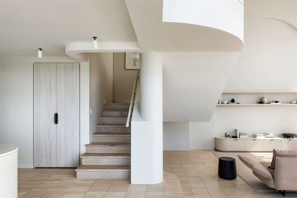 A minimalist living room with a neutral color palette and modern design elements.