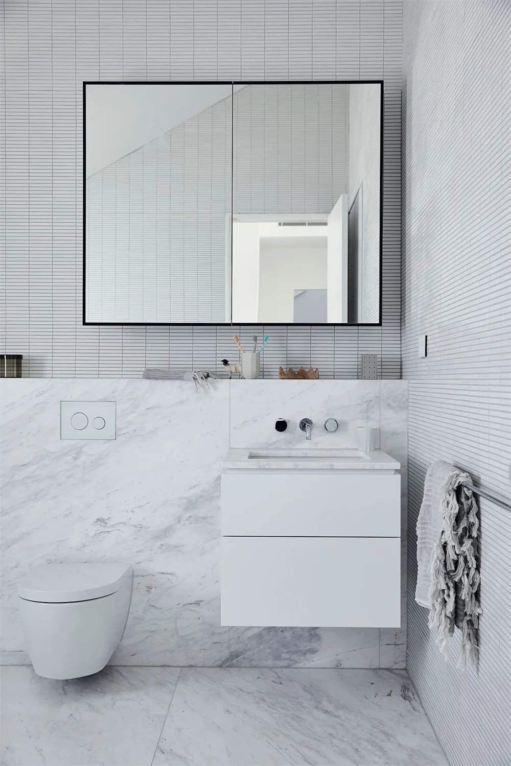 Modern bathroom with marble fixtures and art deco style.