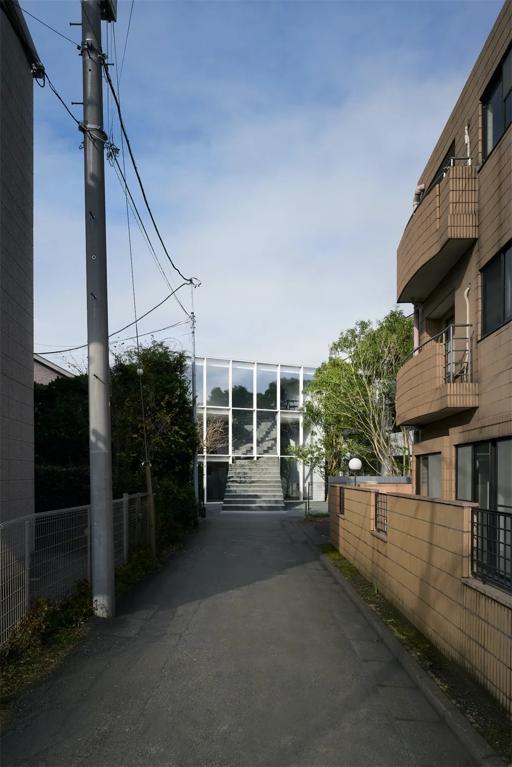 A modern building exterior featuring a combination of aluminum, glass, and concrete materials.