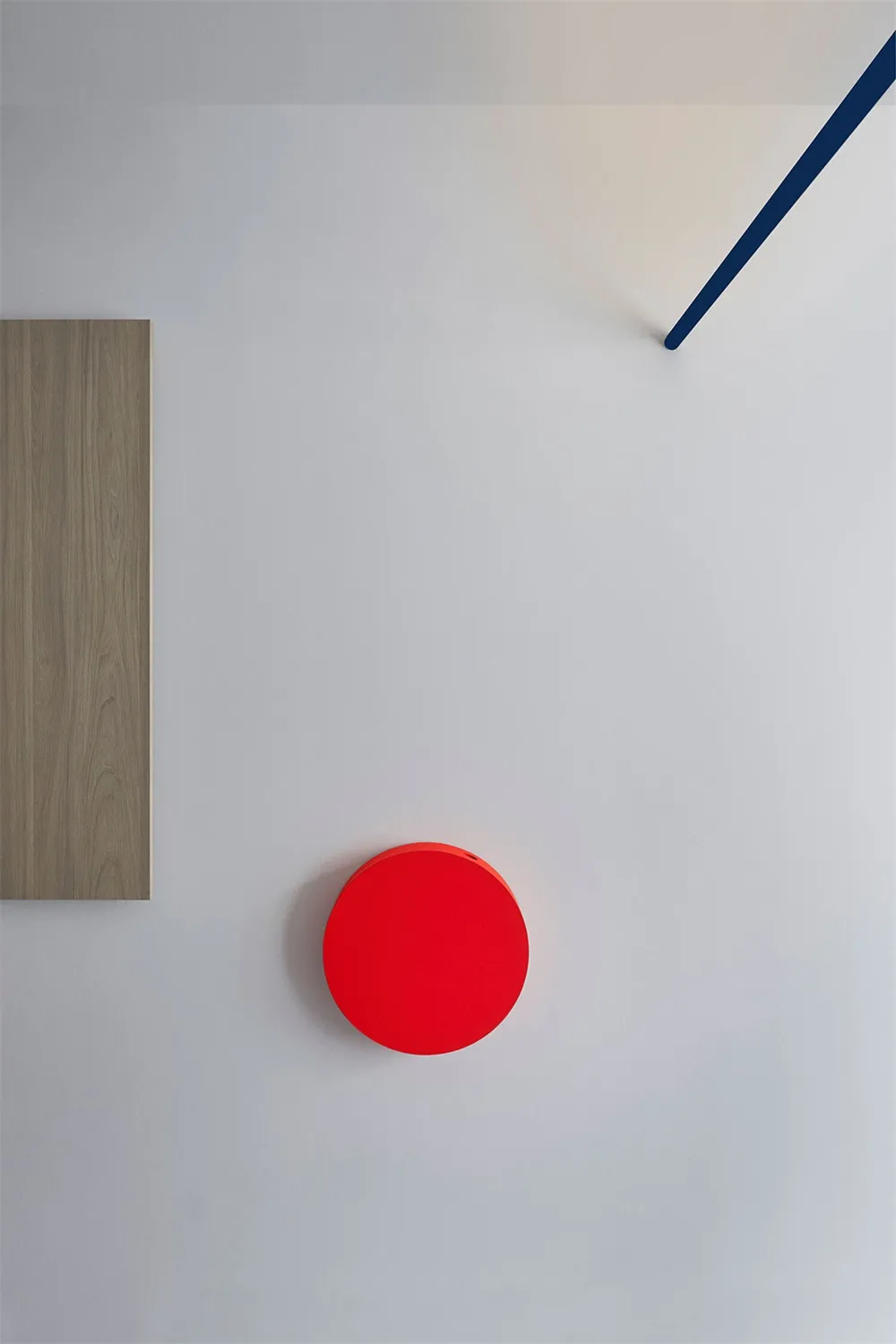 A minimalist interior design featuring a red circular object on a white wall.