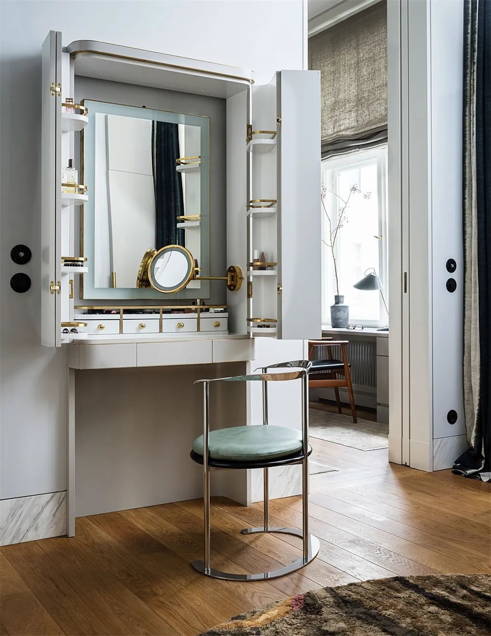 White dresser with brass accents and marble top, featuring a vanity mirror and storage compartments.