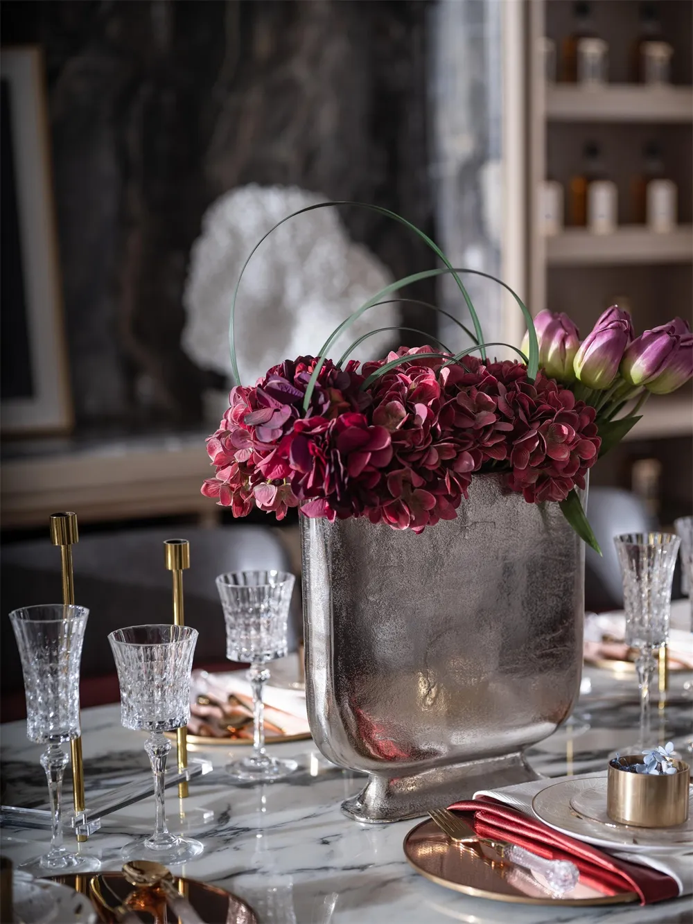 A photograph of an industrial-style interior design featuring metallic and glass elements.