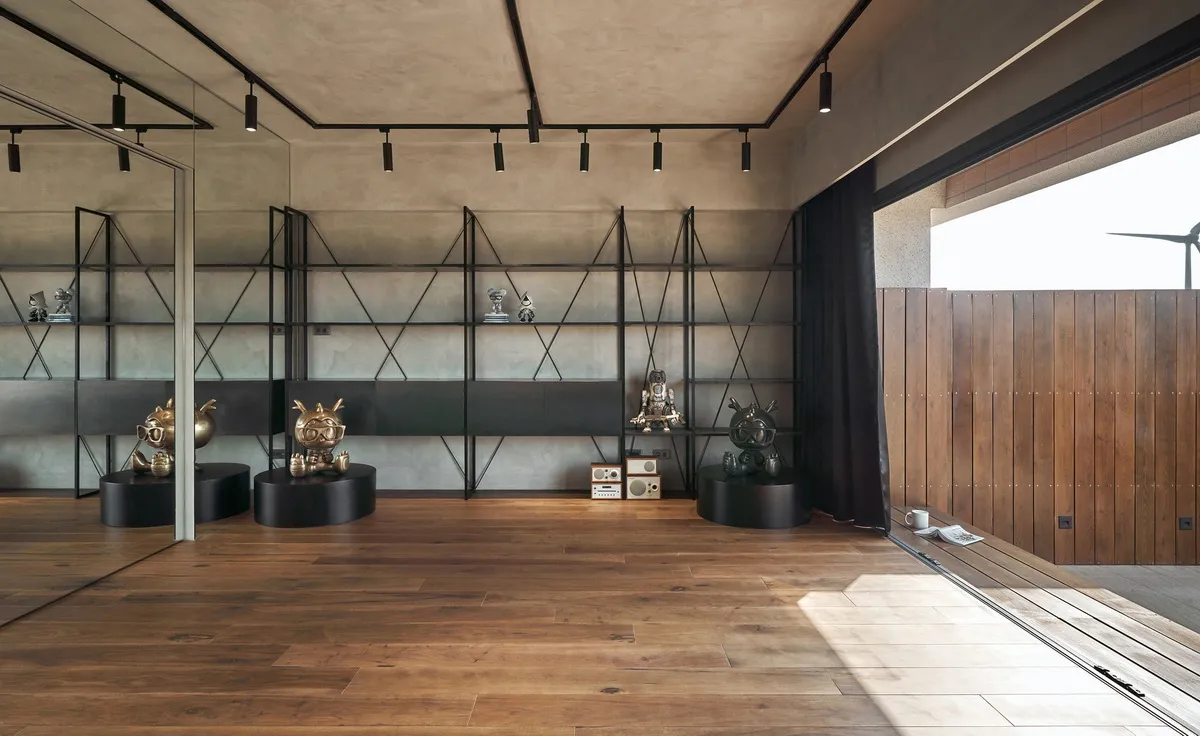 Metal shelving units with various objects on display in an industrial setting.