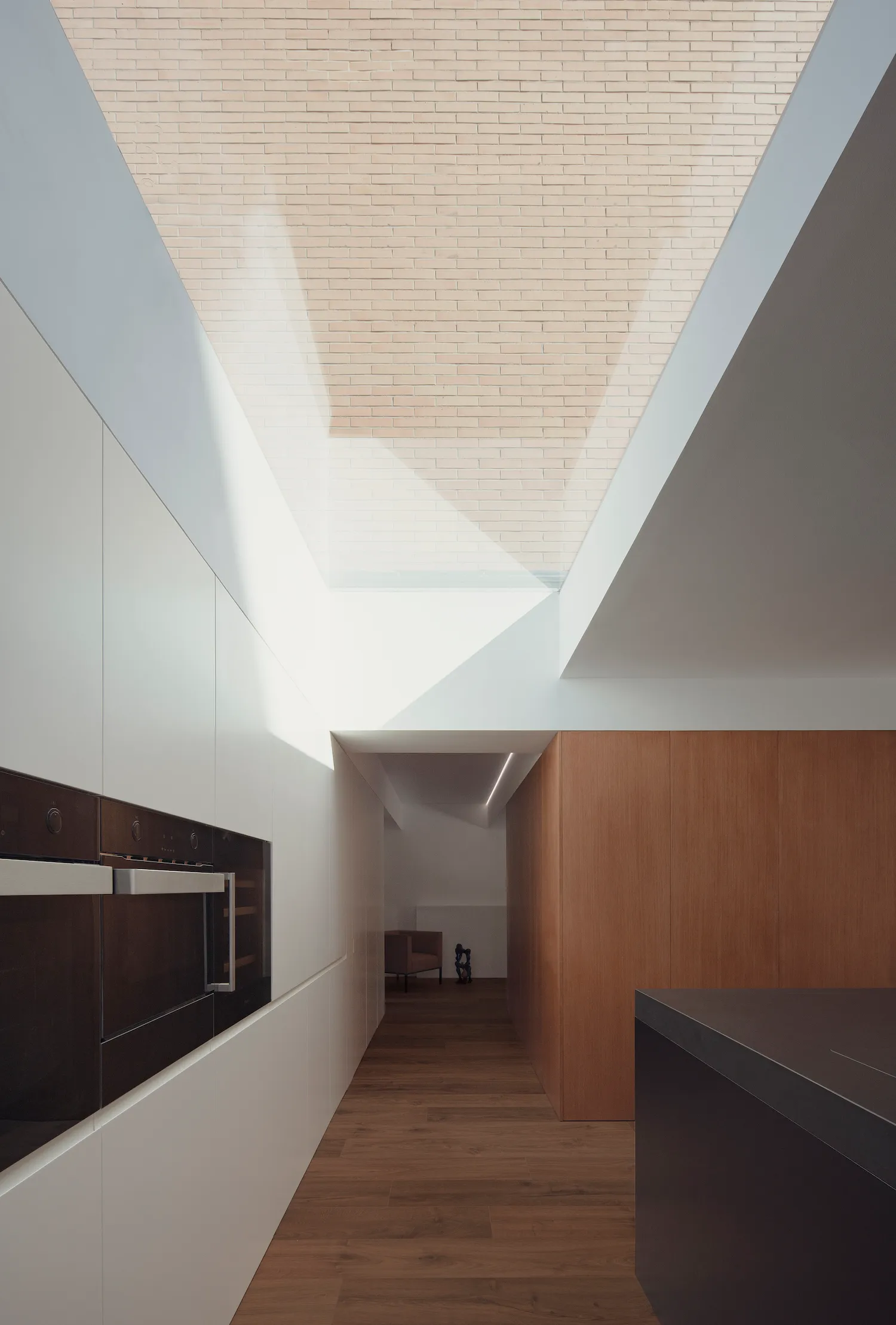 A modern kitchen with white panels featuring sleek, minimalist design.