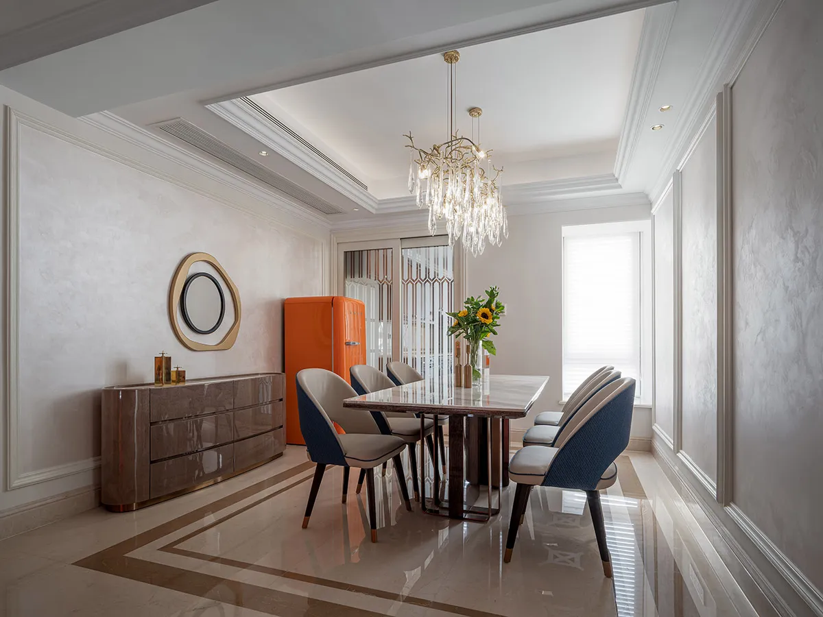 Modern dining room with marble flooring, chairs, and table.