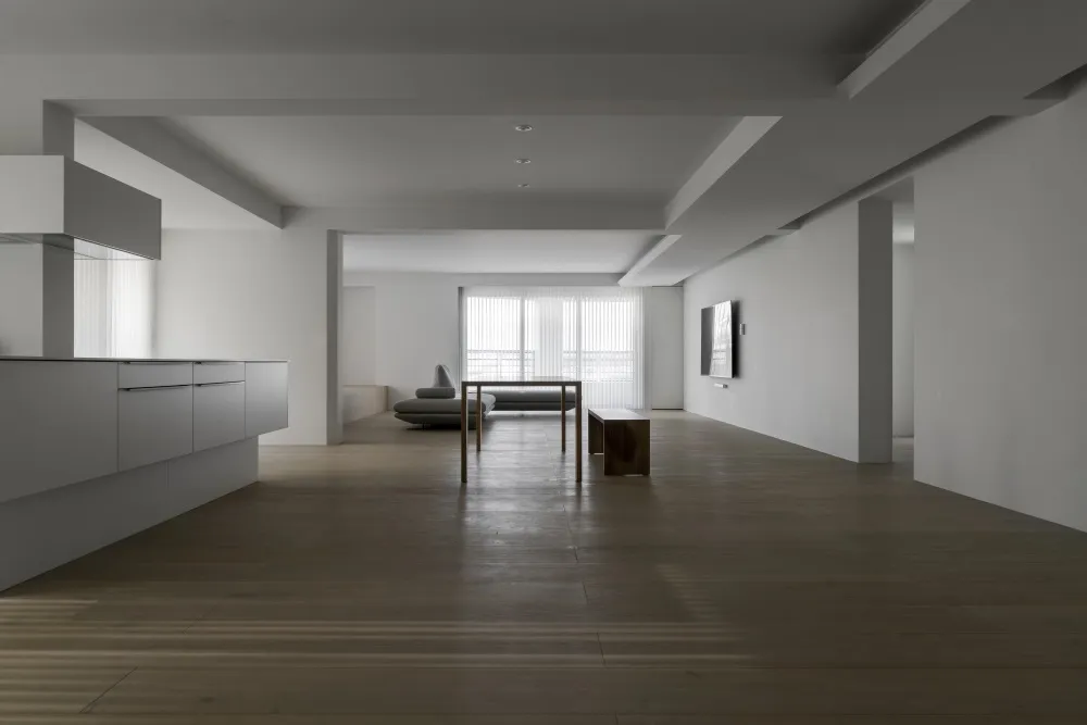 Modern minimalist interior design featuring wooden flooring and glass elements.