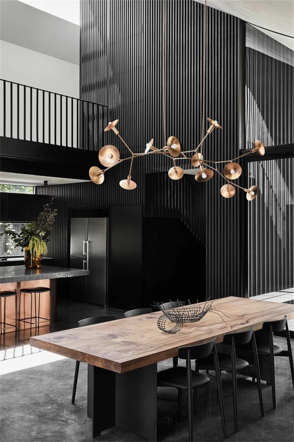 Modern industrial dining space featuring a wooden table and concrete floor.