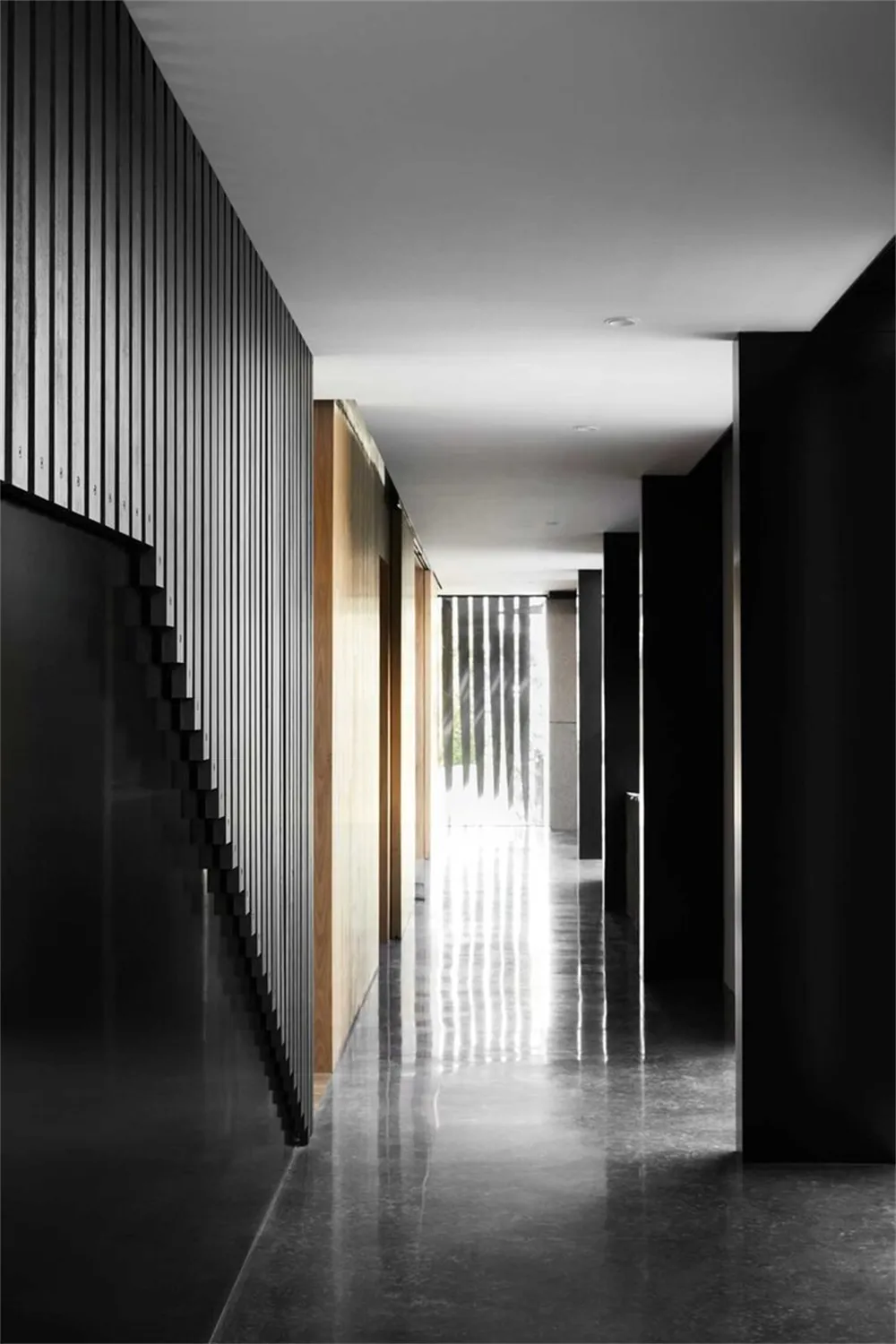 An image of a minimalist hallway featuring concrete and wood materials.