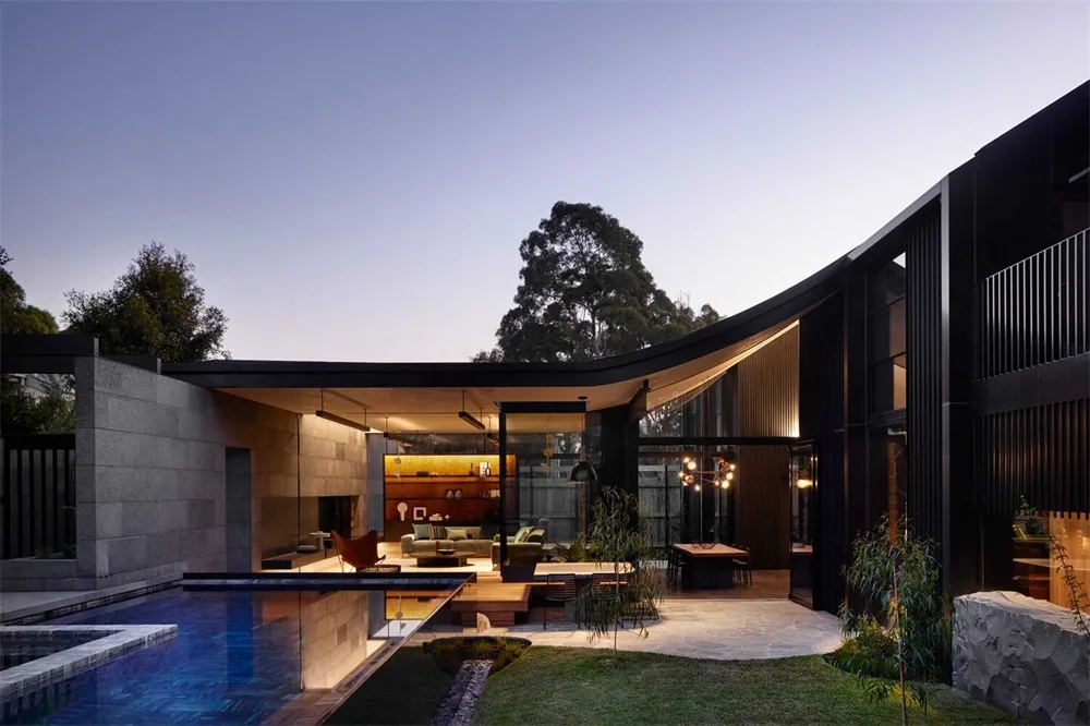 Modern house featuring stone, brick, and glass elements.