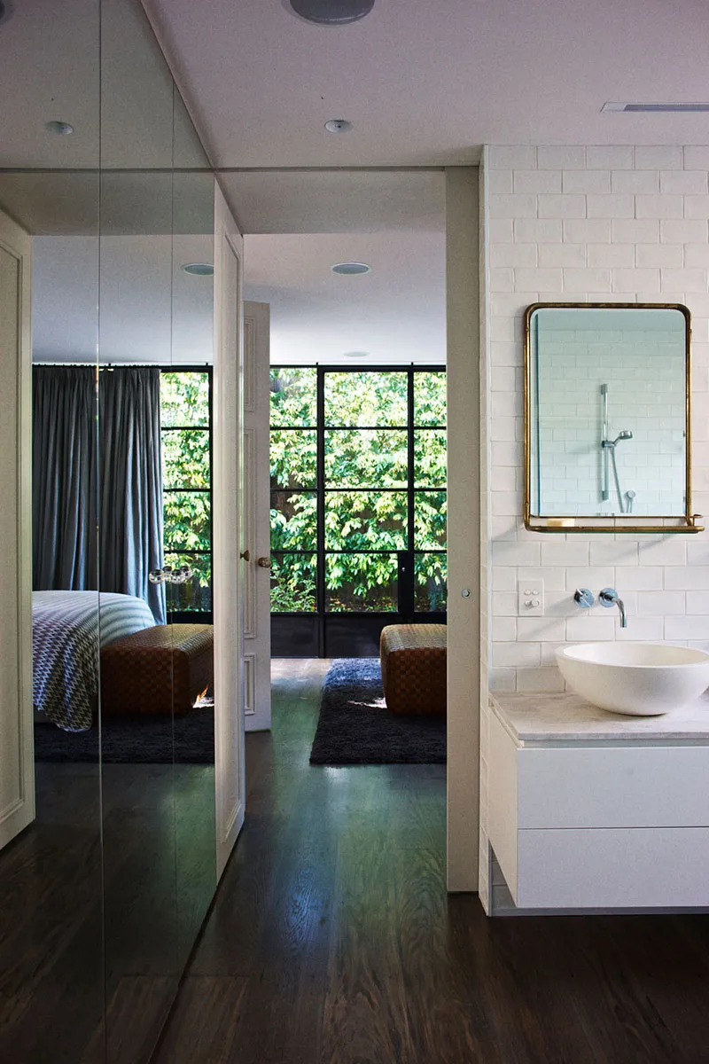 Modern bathroom with white tiled walls and a minimalist design.
