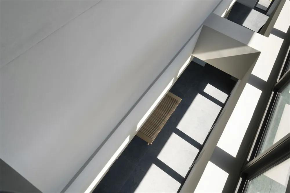 A minimalist interior with concrete and glass materials.
