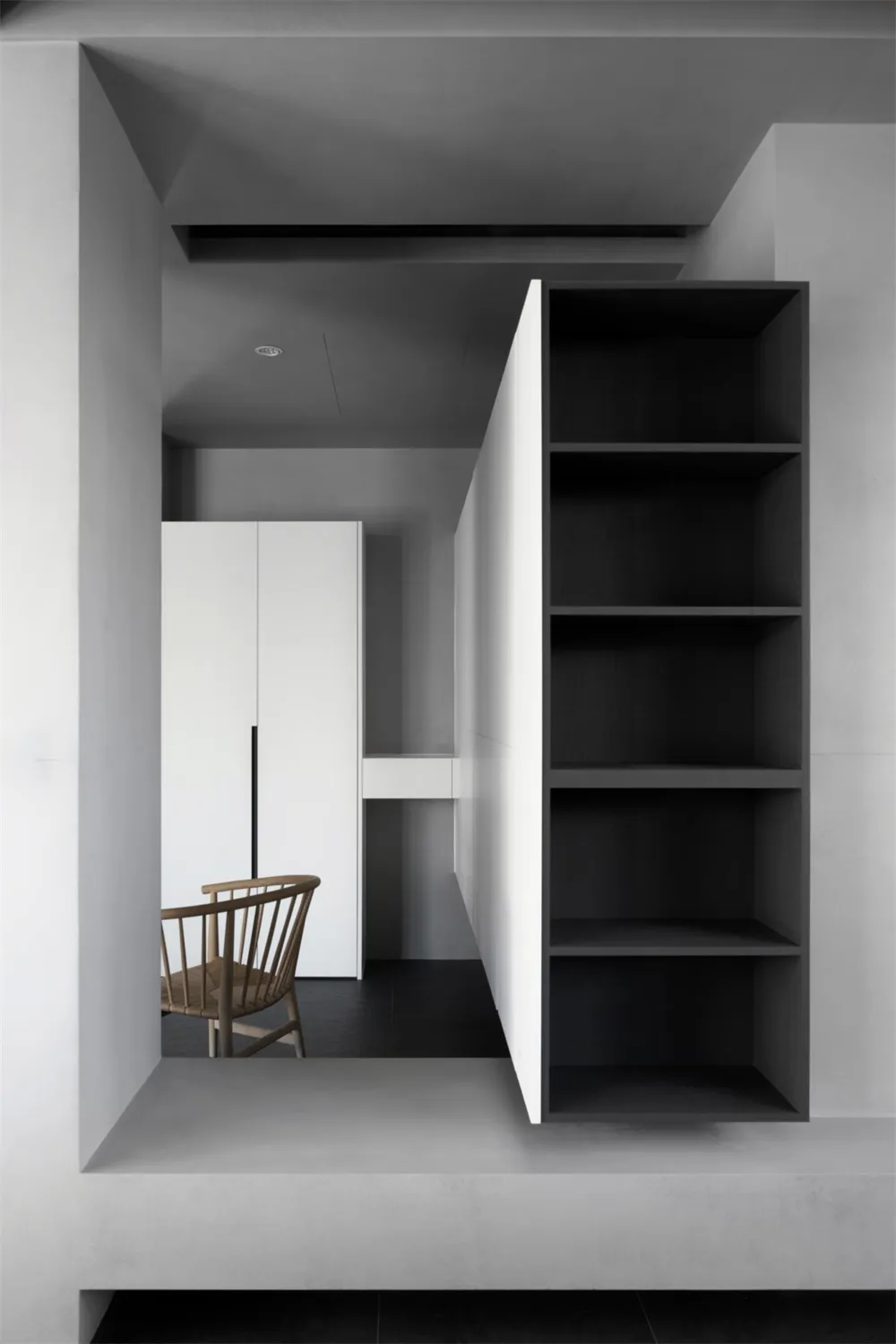 Modern interior design featuring a minimalist space with concrete walls and wooden furniture.