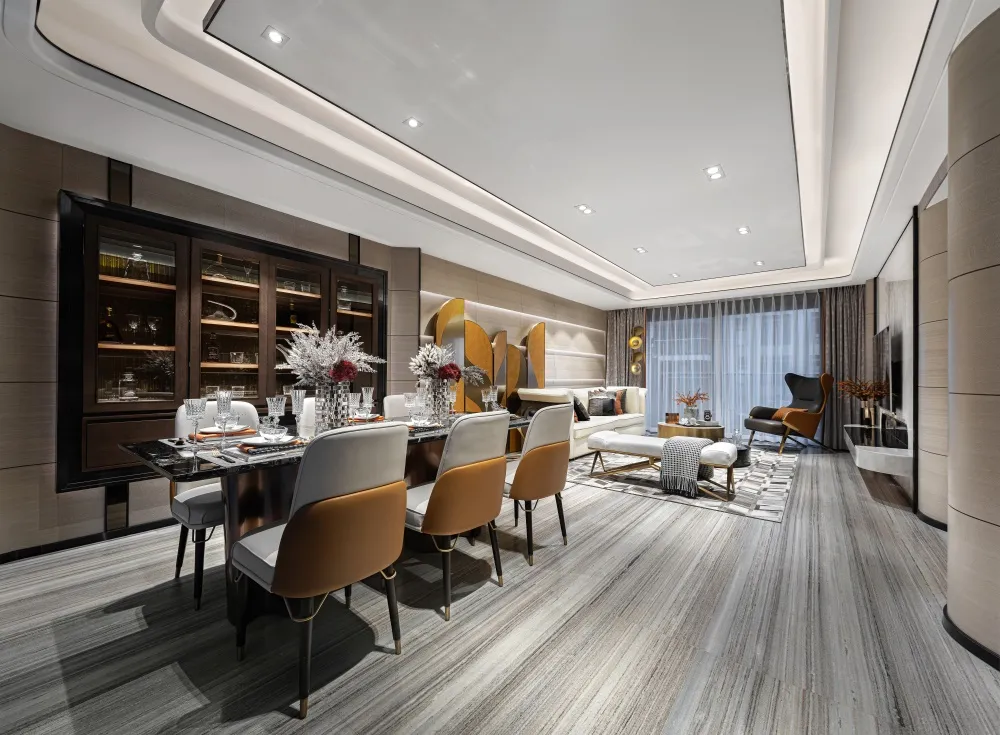Modern living room with wooden flooring, leather chairs, and glass tables.