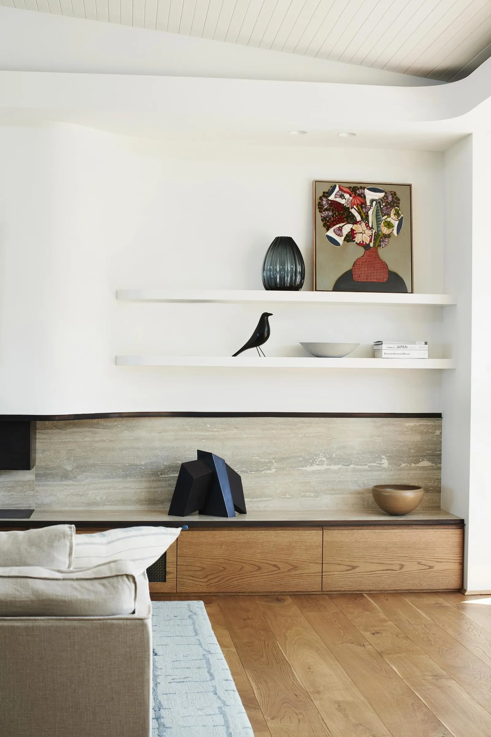 A modern living room featuring wood flooring, ceramic wallpaper, and metal accents, with a minimalist design aesthetic.