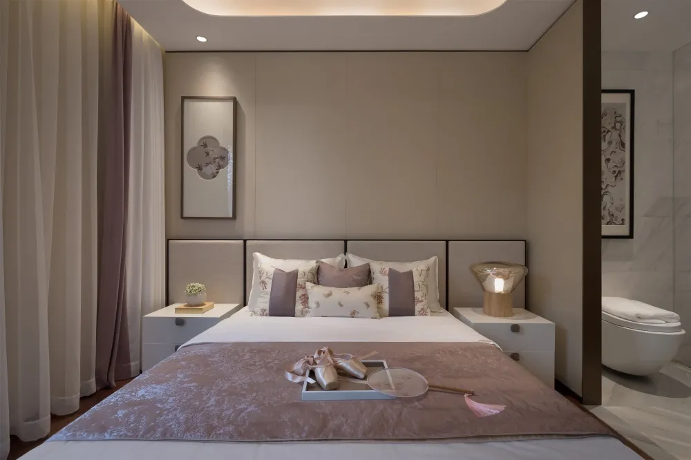 Modern minimalist bedroom with a bed featuring floral-patterned bedding, white and beige tones, and a floating bedside table