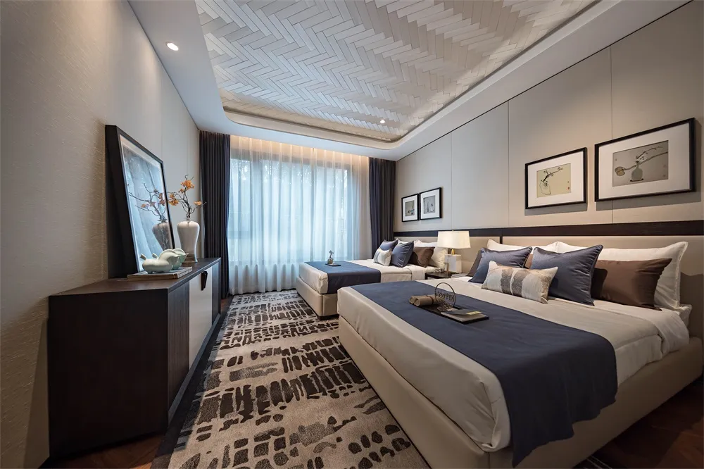 Contemporary bedroom with neutral-colored fabrics and modern lighting.