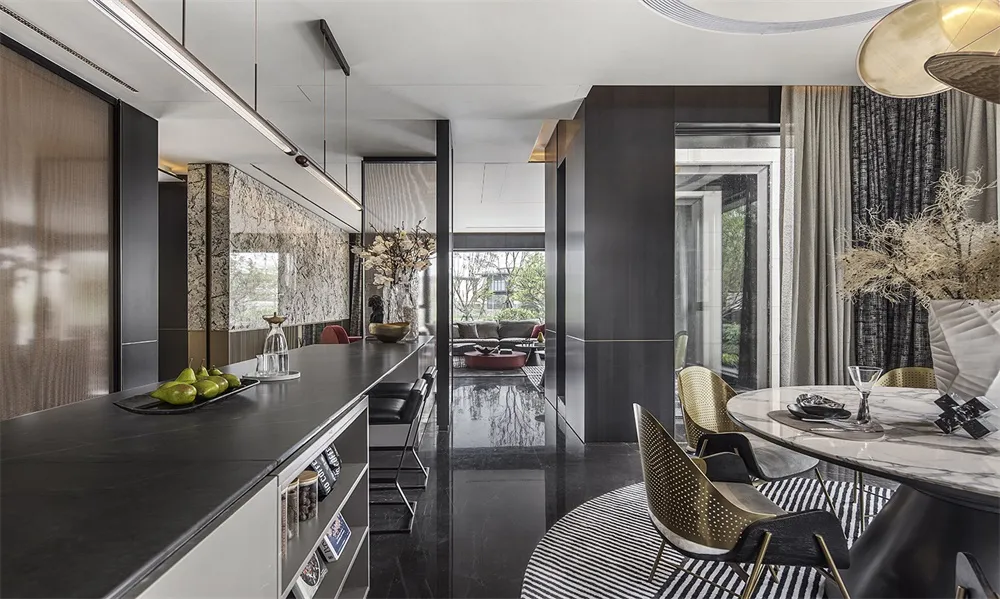 Modern residential kitchen featuring dark marble countertops and a black tile floor.