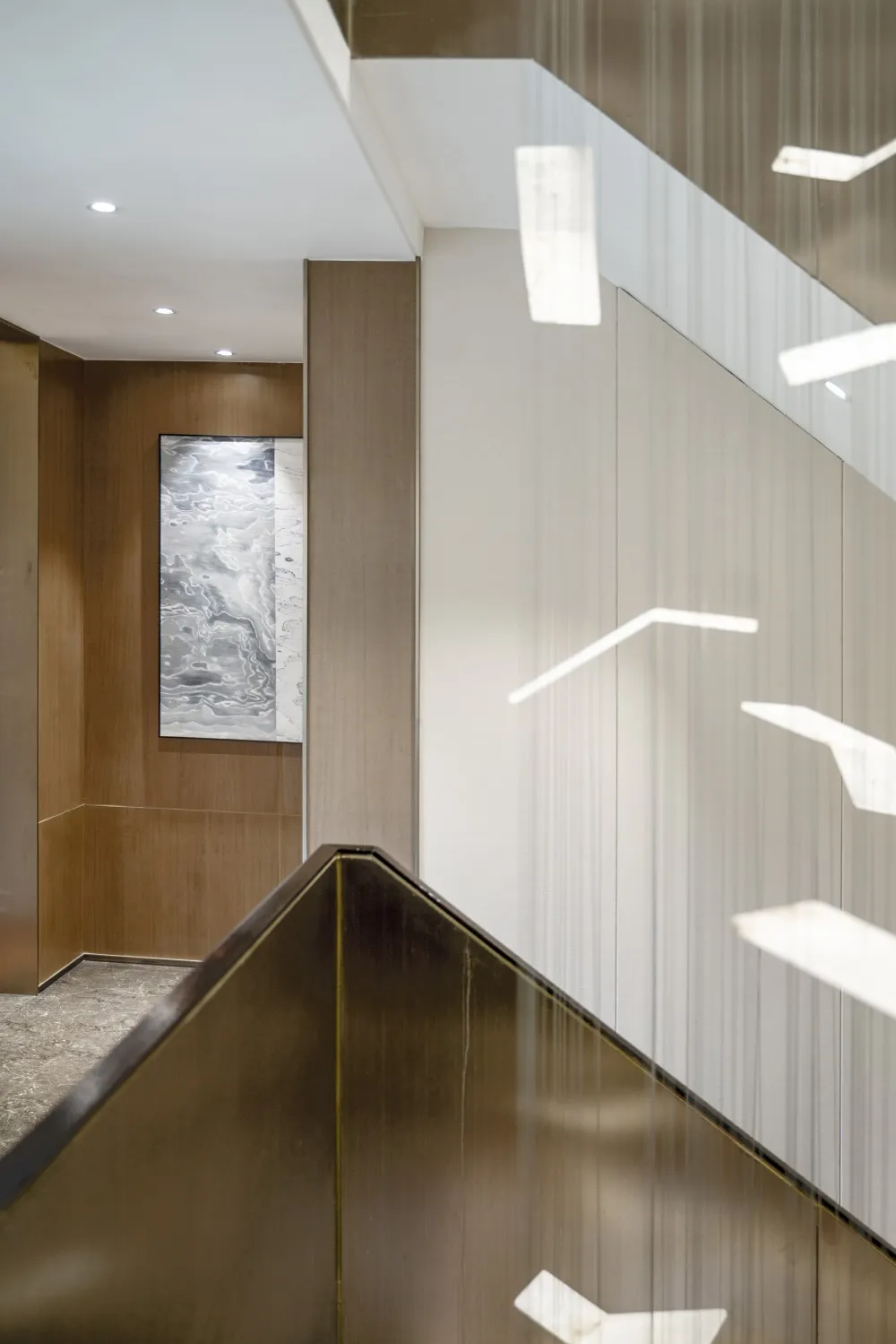Modern office staircase featuring metal-clad banisters and paneling, with a sleek, contemporary design.