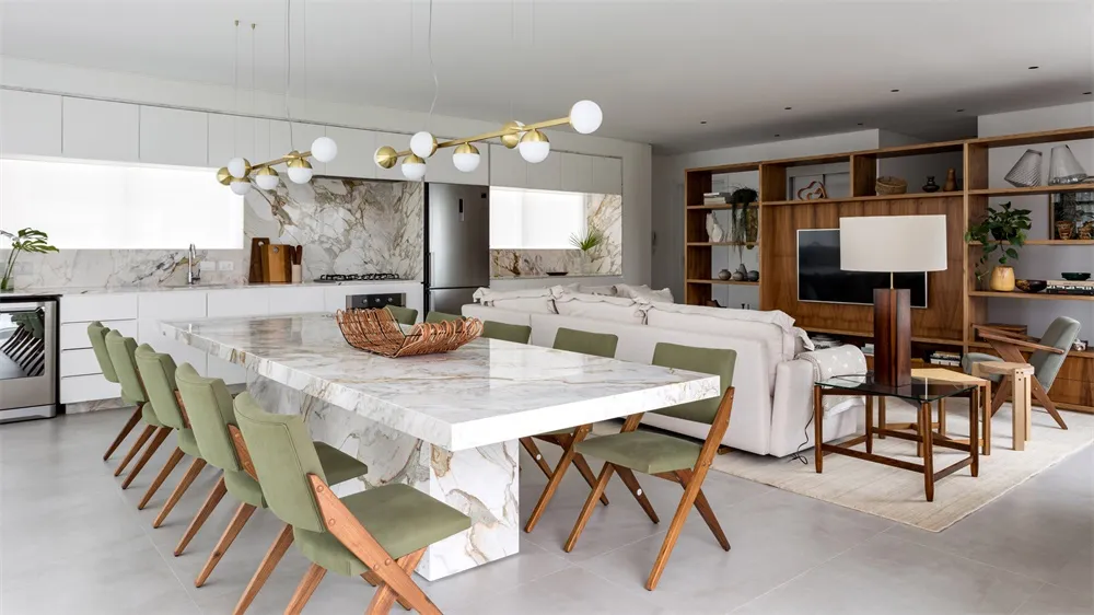 A modern residential interior with a marble dining table and wooden chairs.