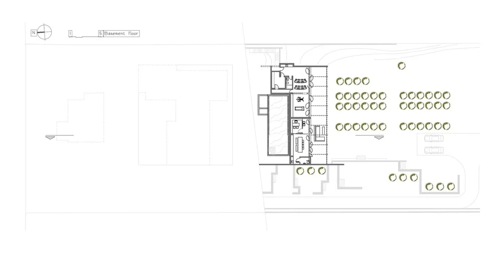 A building section plan showing the layout of different sections of a building including rooms, corridors, and outdoor spaces