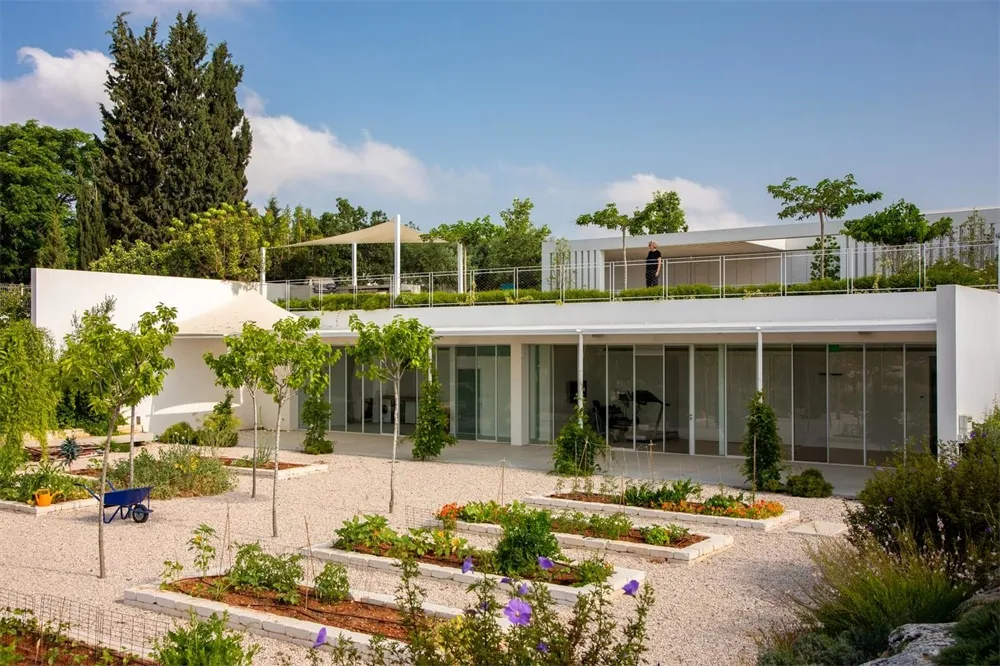 An image depicting a modern office space with glass walls and concrete accents.