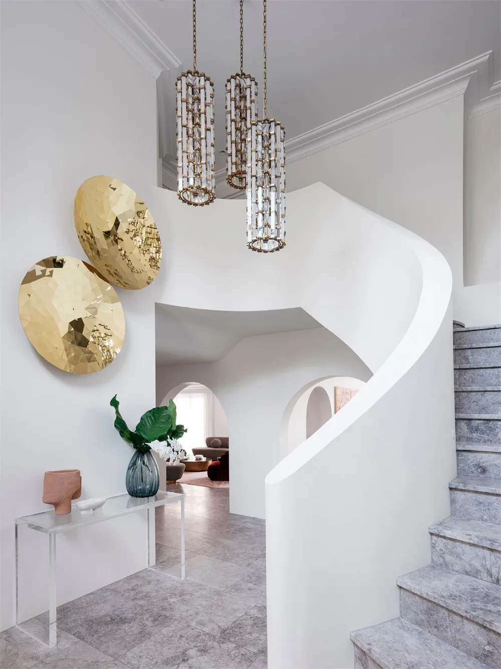 Modern staircase with marble and cement materials and a glass console table.