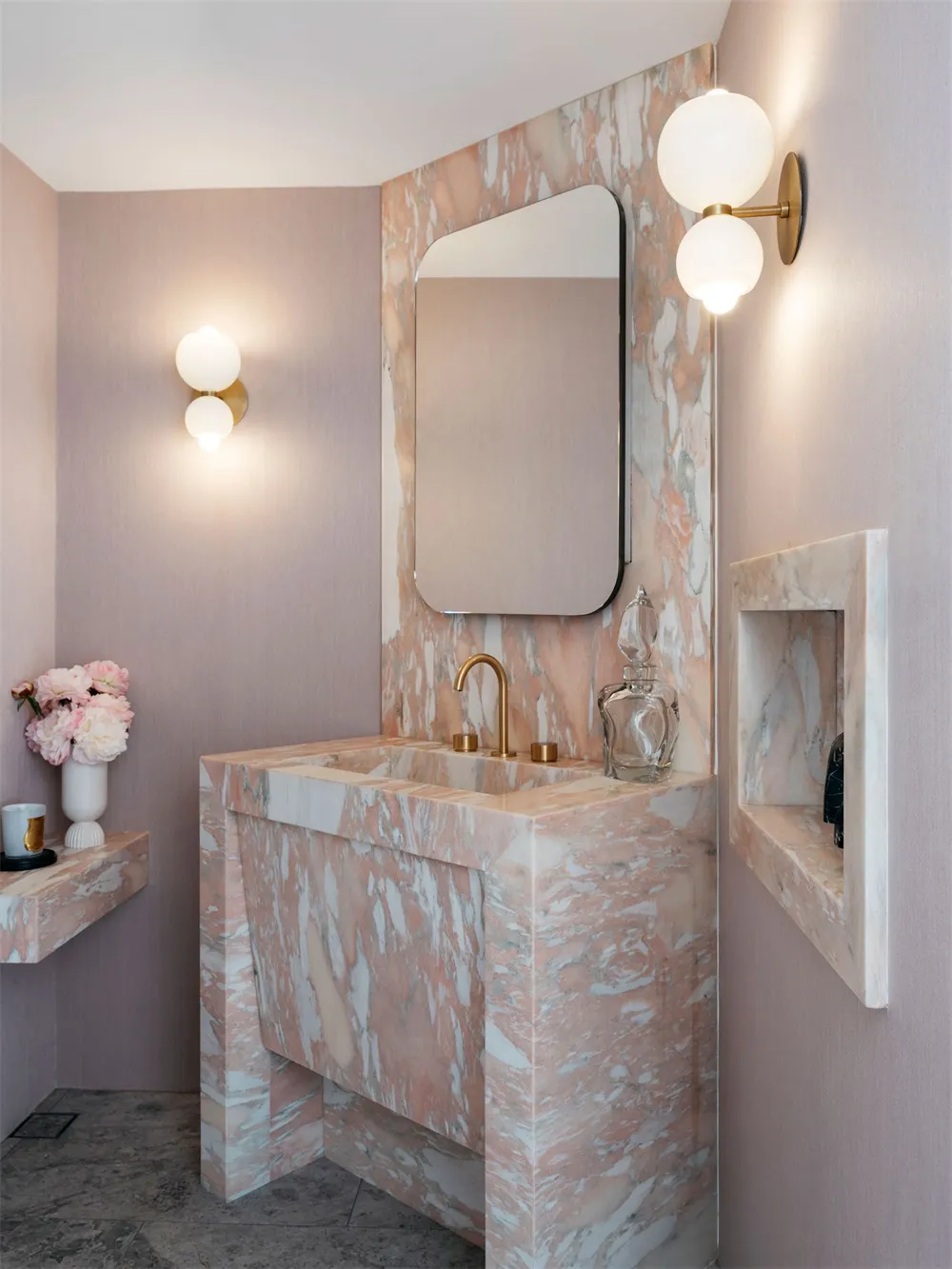 Modern bathroom featuring marble finishes and minimalist design.