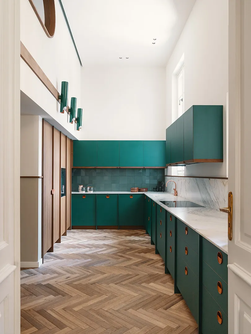 Modern kitchen with green painted cabinets and walnut accents