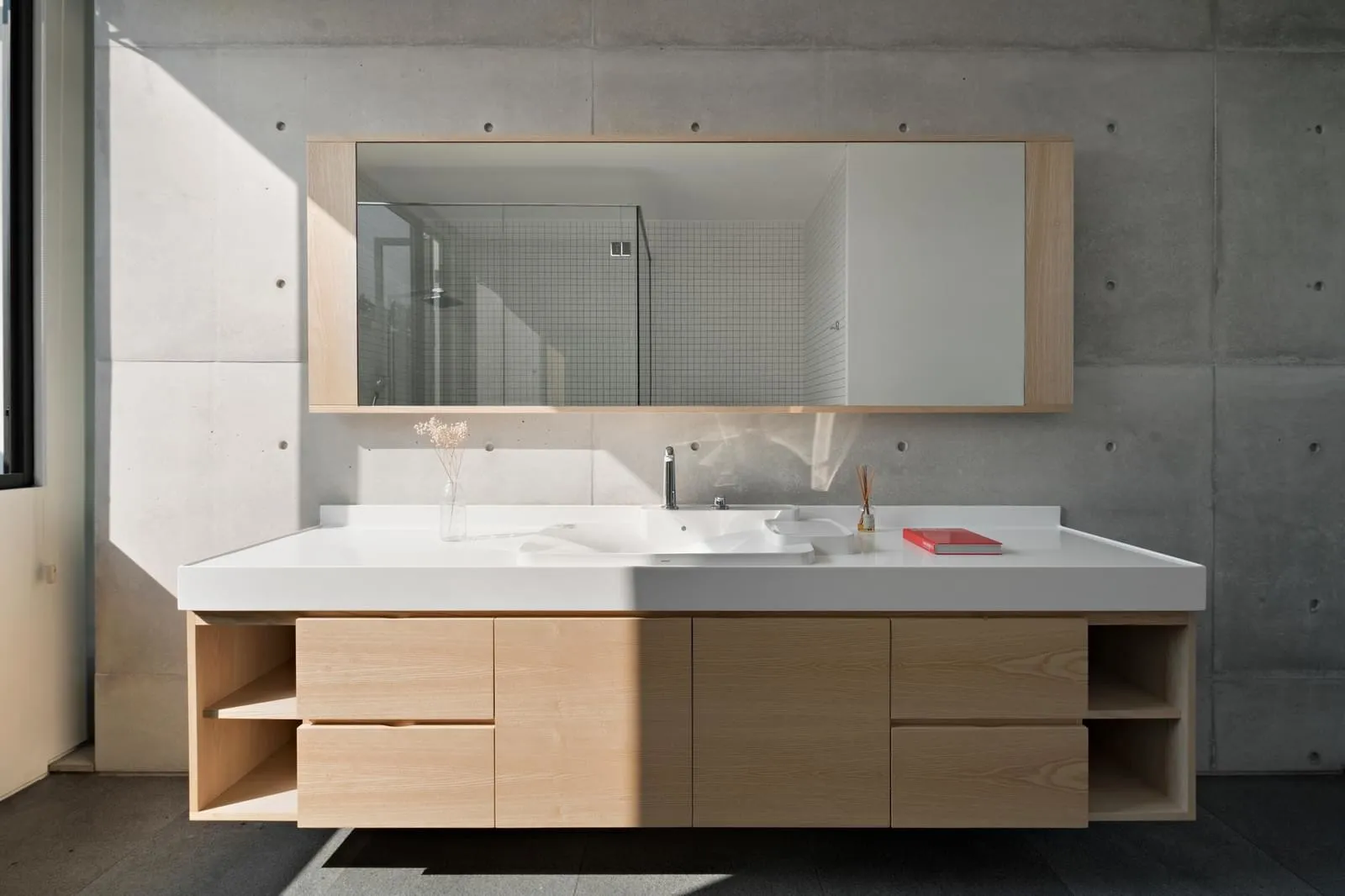 Modern bathroom vanities featuring a sleek, minimalist design with concrete materials.
