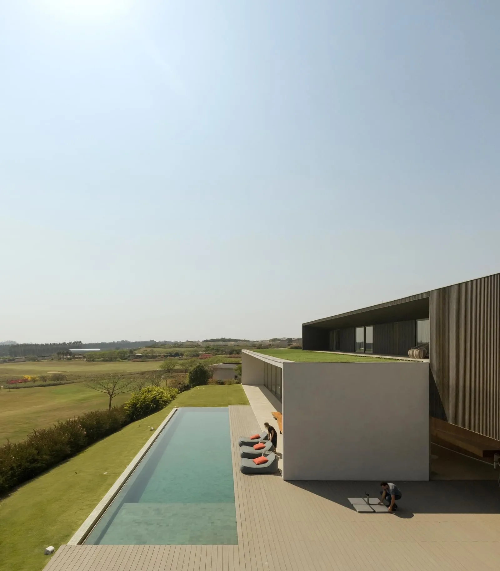 A modern house exterior featuring concrete and glass materials.