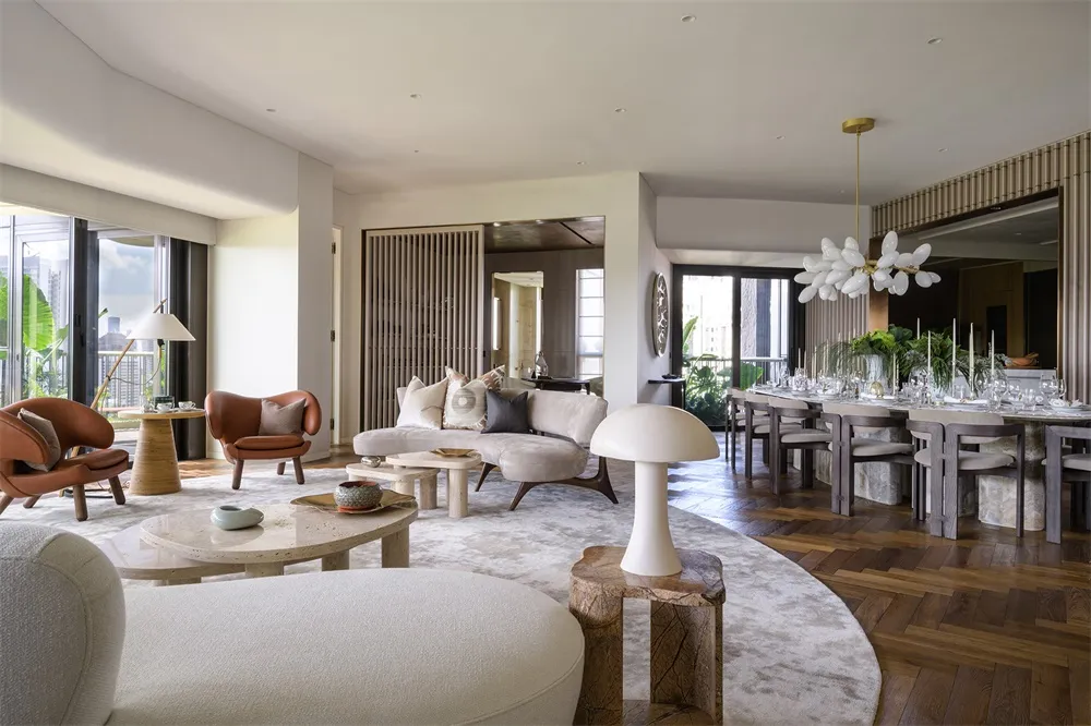 A modern interior design featuring living and dining areas with a mix of wood texture, concrete, marble, leather, and fabric