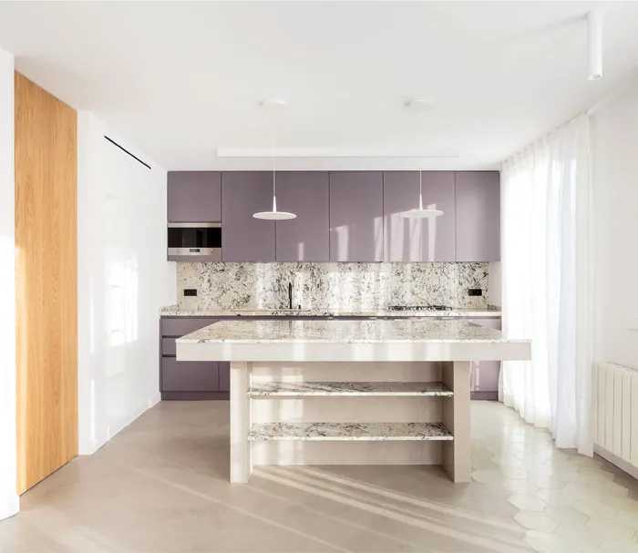 A modern minimalist kitchen with a marble countertop and lavender cabinets.
