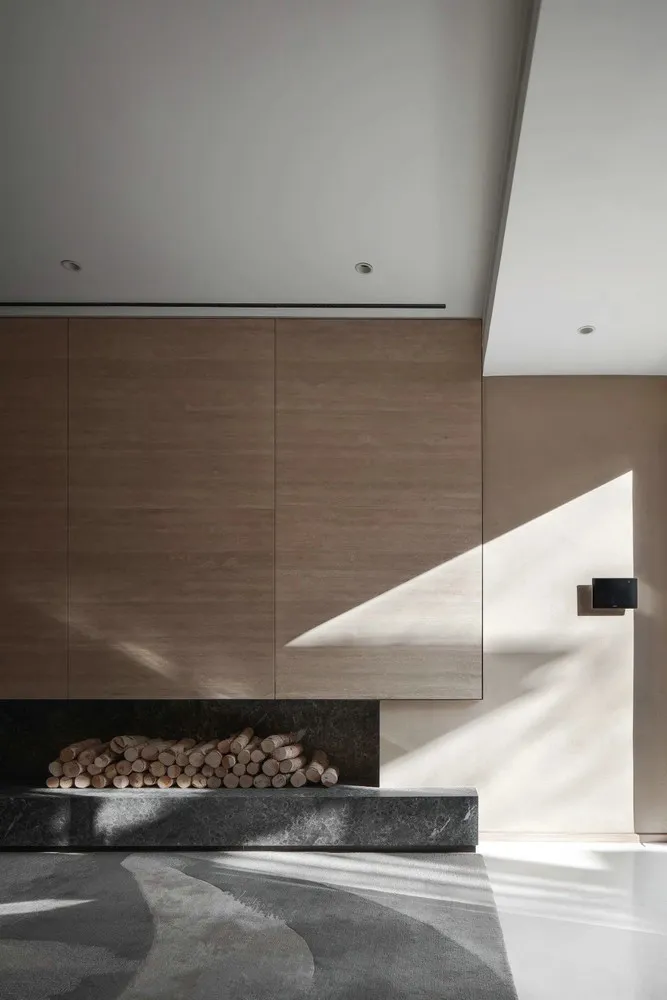 A modern living room featuring wooden panels and a marble floor.