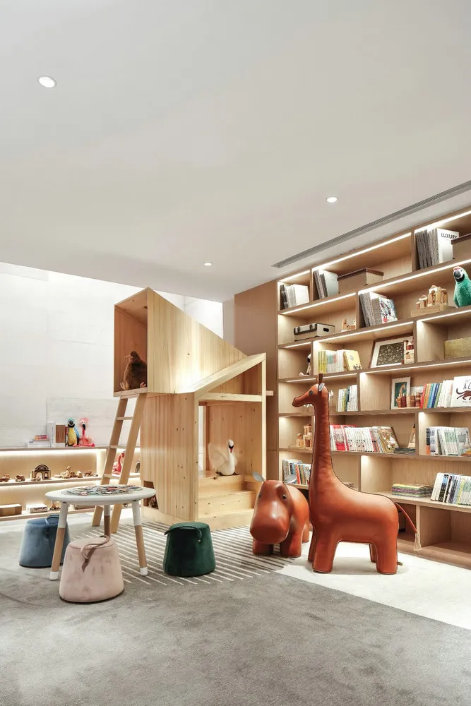 A modern children's playroom featuring wooden furniture and colorful toys.
