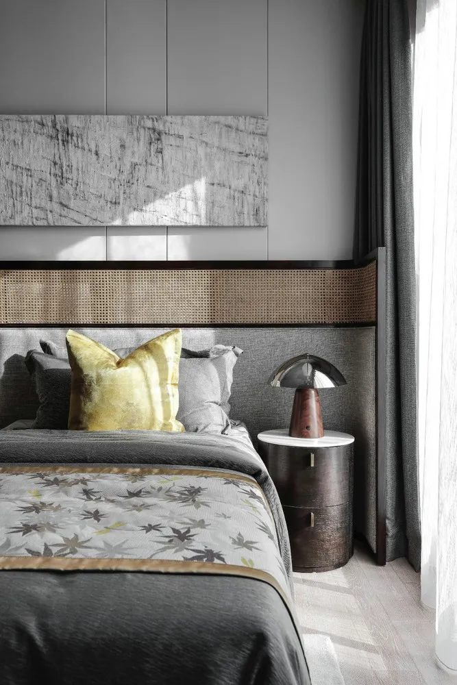 Modern bedroom featuring textured wood headboard and rattan accents