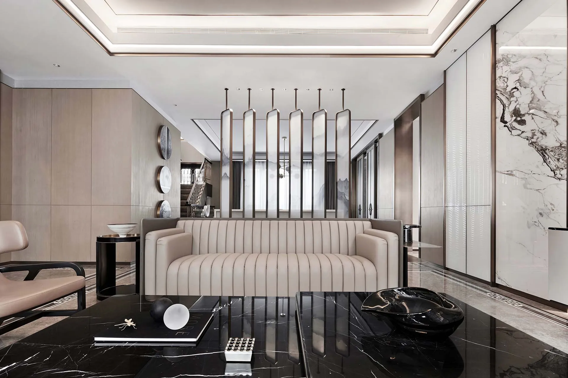 Modern living room featuring a sleek, light-colored leather couch against a minimalist backdrop.