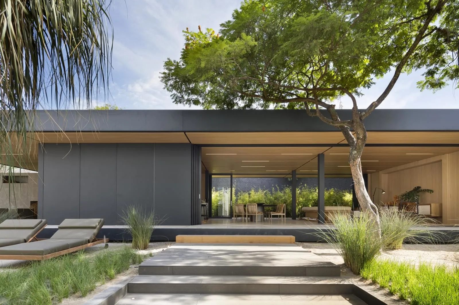 Modern residential exterior featuring glass and wood materials.
