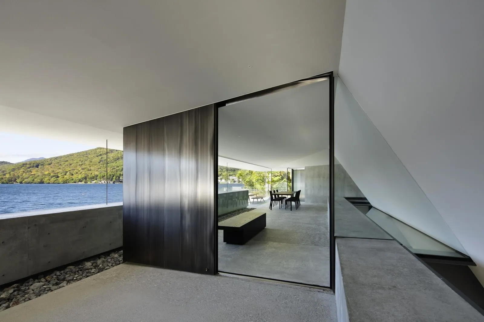 Modern residential interior with concrete and glass materials.