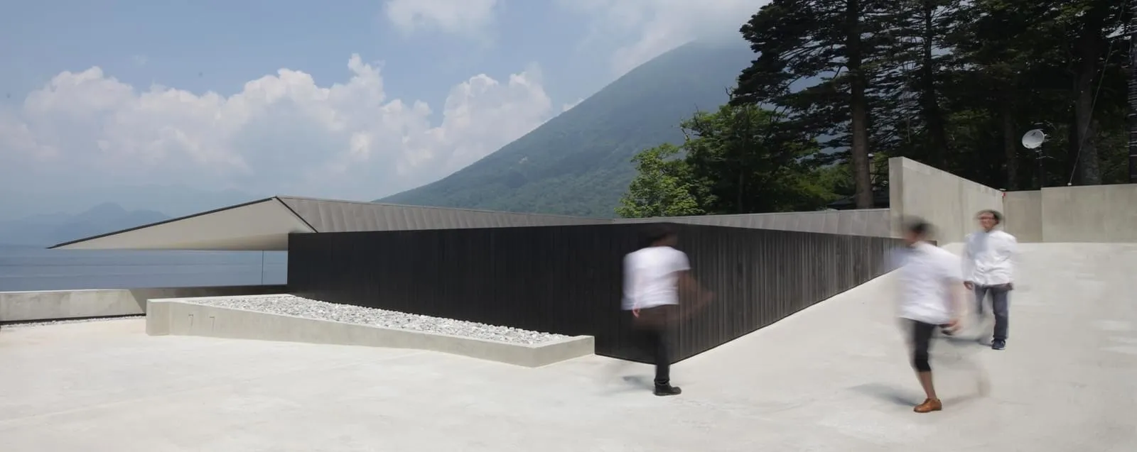 A modern interior with concrete walls, floors, and a minimalist design.