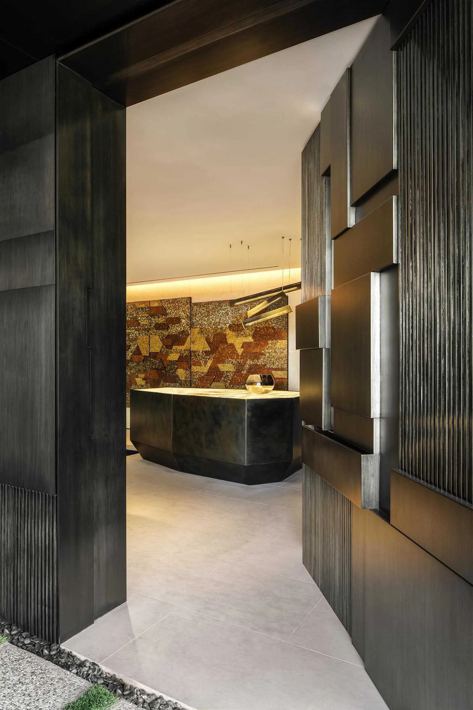 Modern hotel reception area with metallic and leather accents