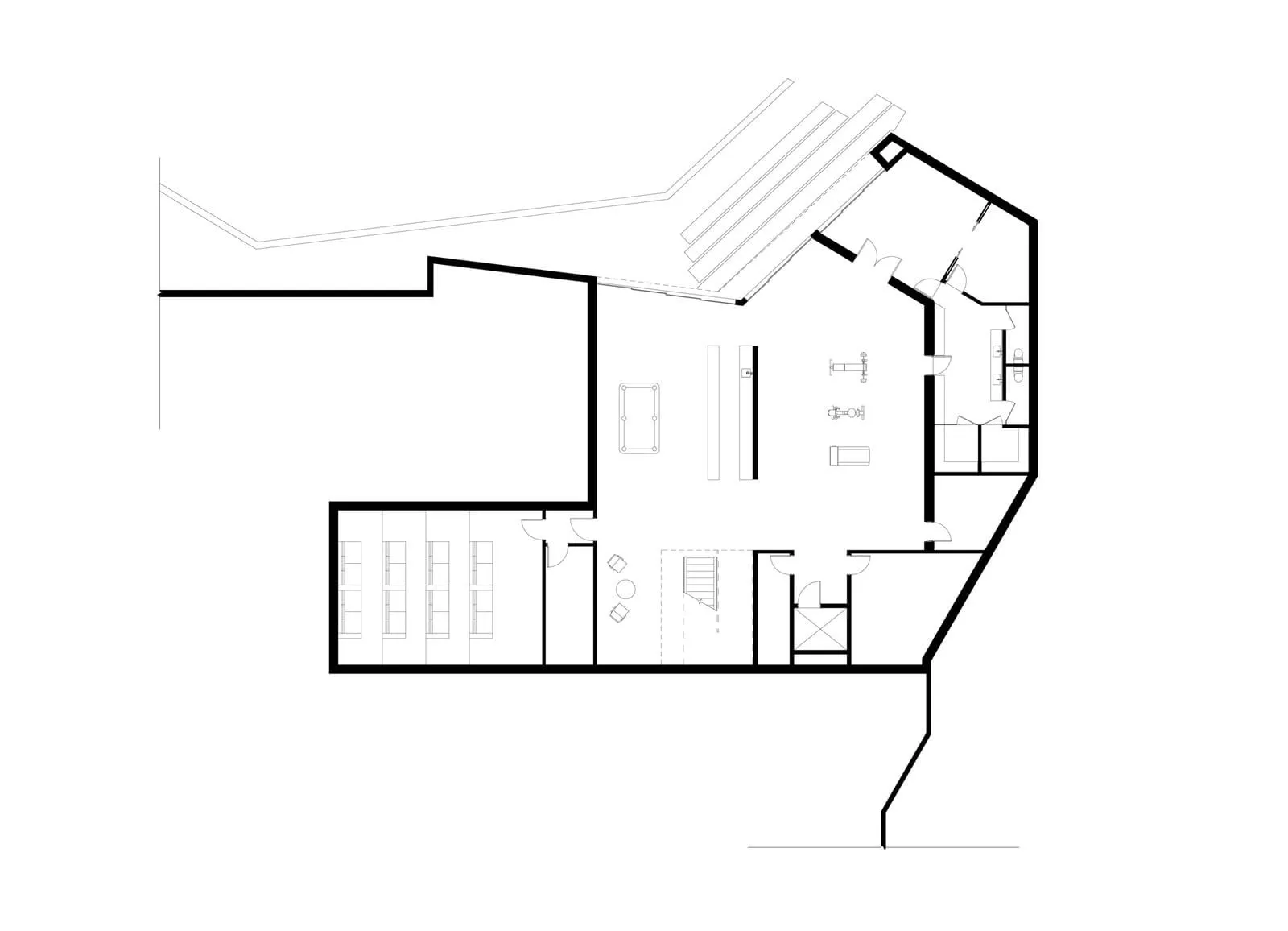 Black and white architectural drawing of an office layout with a desk, chairs, and computer monitor.