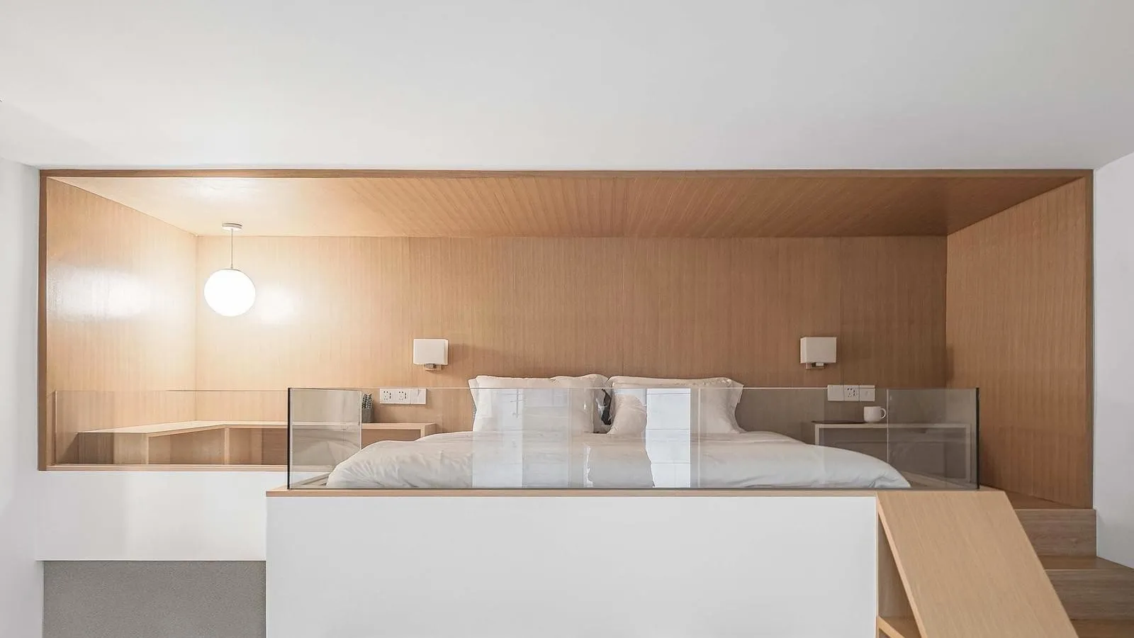 A minimalist bedroom with wooden elements, including a bed, nightstands, and a ceiling.