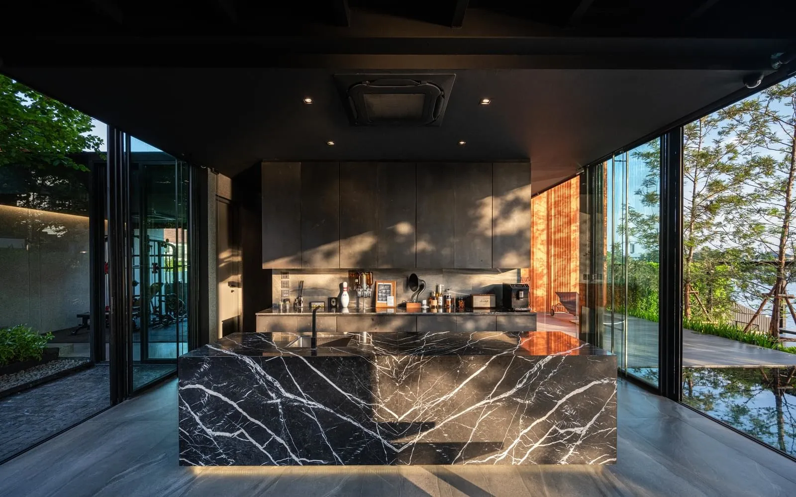 Modern kitchen featuring a marble countertop and island in a minimalist design.