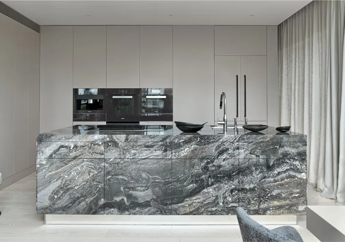 A modern kitchen featuring a marble countertop and a minimalist design.