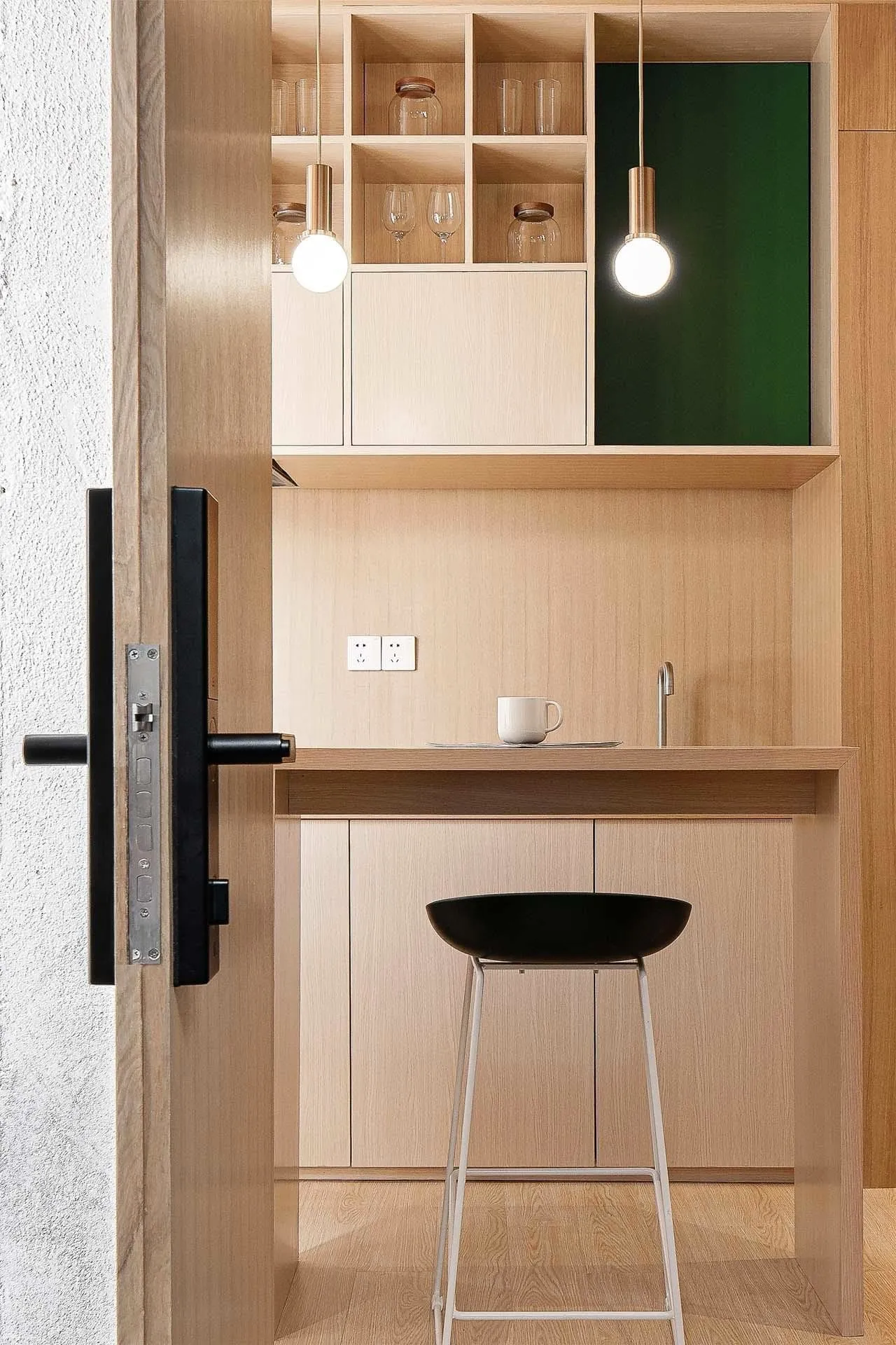 Modern minimalist kitchen featuring wood cabinets and minimalist design elements.