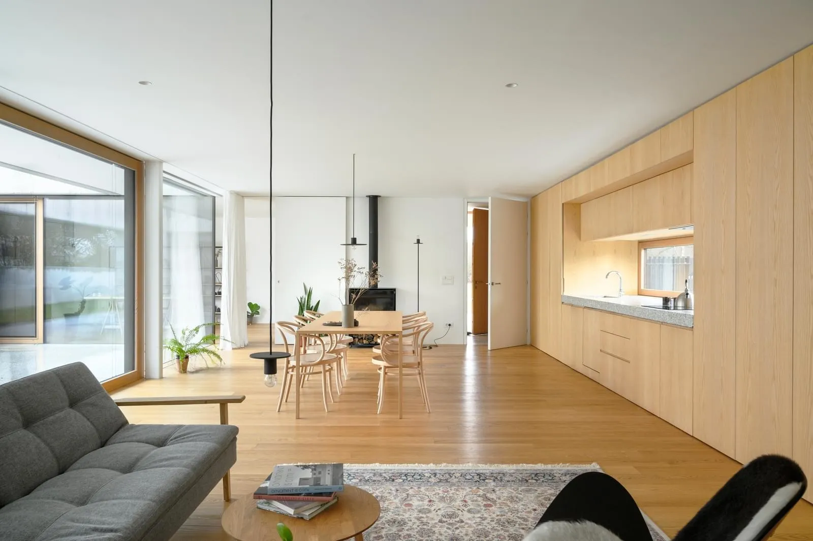 Interior design featuring a modern residential space with wooden elements and a minimalist aesthetic.