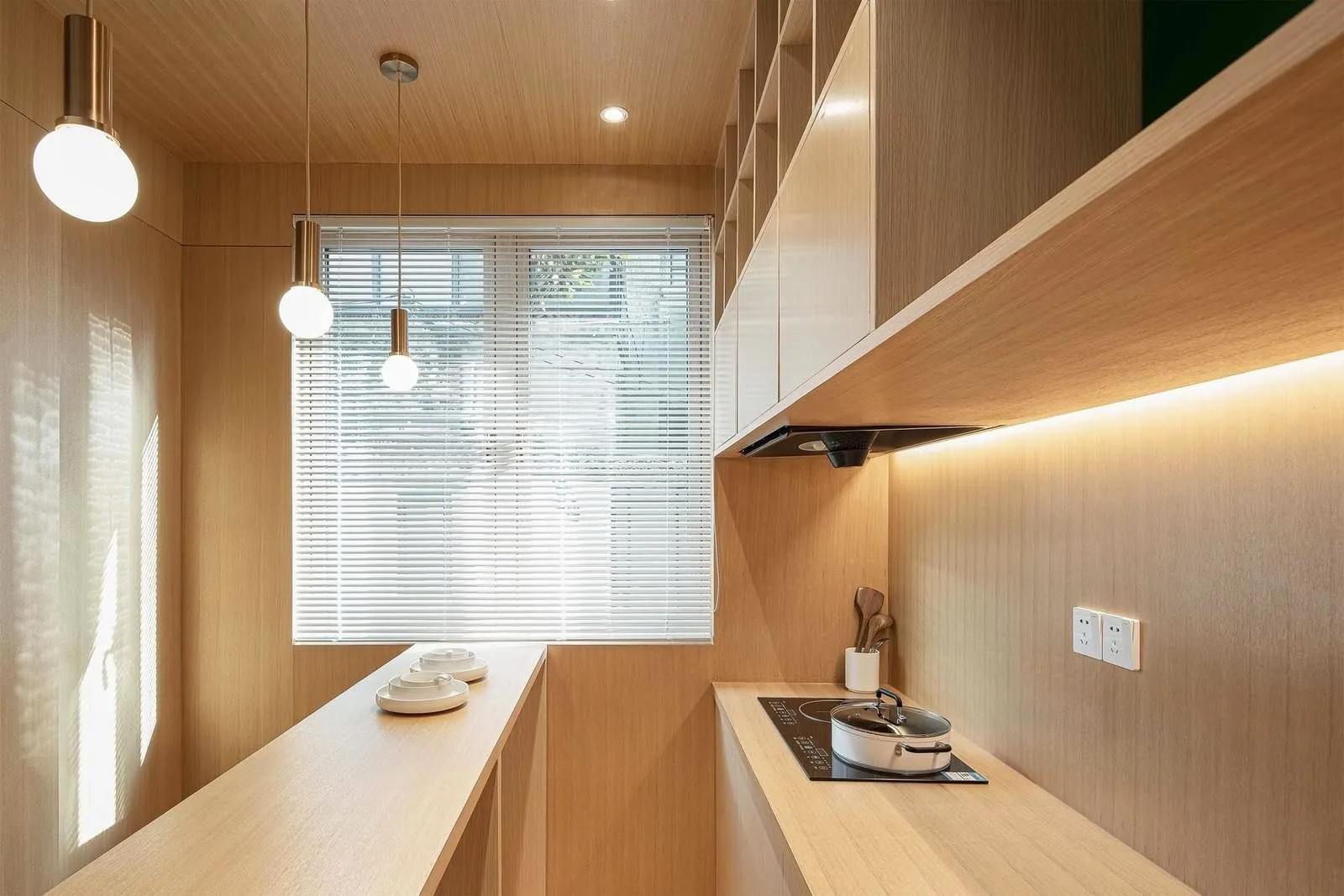 A modern kitchen with wooden panels and stainless steel appliances.