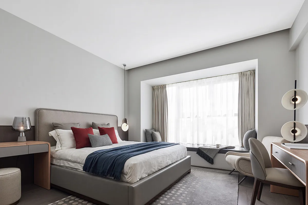 A modern bedroom featuring contemporary furniture and minimalist decor.
